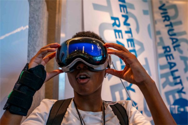  A student reacts to looking through virtual reality goggles. 