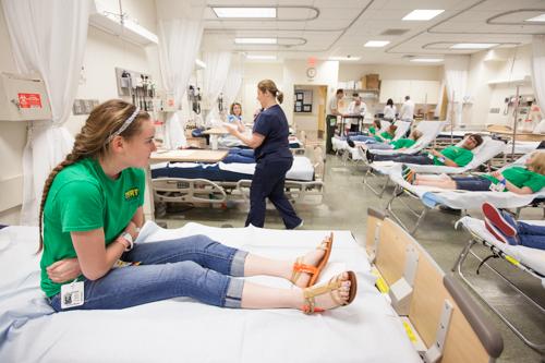 Volunteer patients present symptoms of nausea during a mock disaster exercise at the Cook-DeVos Center for Health Sciences.