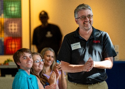 Michael Gerstweiler, owner of Pribusin Inc., reacts near his family, (from left) Nick Gerstweiler, Jessica Gerstweiler and wife, Sue Gerstweiler, after winning the 2024 Lakeshore Innovator of the Year award at the Muskegon Innovation Hub on July 25.