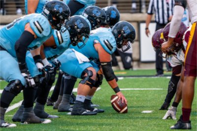 Grand Valley offensive linemen line up along the line of scrimmage against Central State defense.