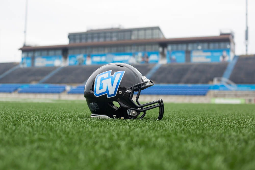football helmet on field with GV athletic logo