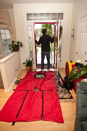 An energy-certified contractor begins a home energy assessment.