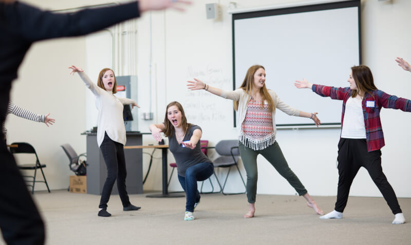 Local high school students practicing theatrical movements.