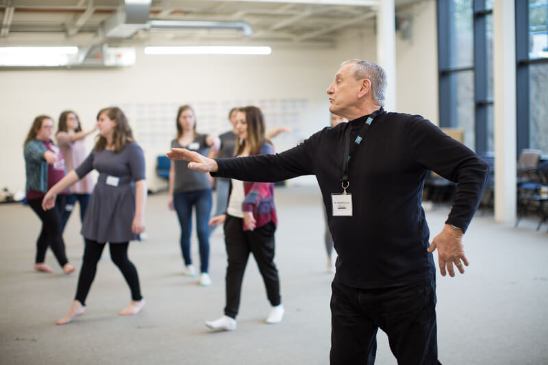 Roger Ellis, professor of theater, guiding students through theatrical movements. 