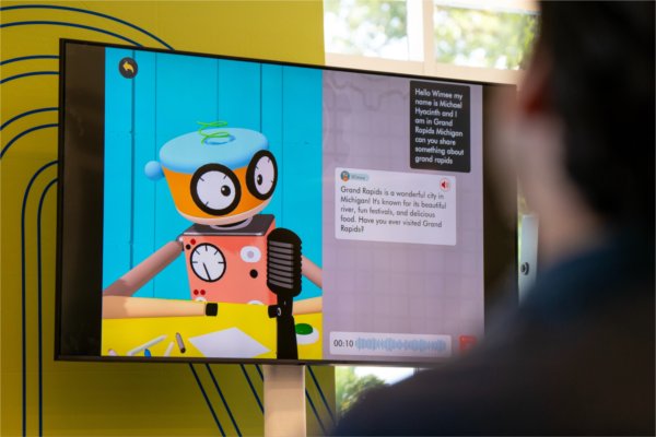 AI is displayed on a screen as Michael Hyacinthe, founder / CEO of Wimage LLC, speaks as part of the Tech Talks series focused on AI and Data at the John G. Russell Leadership Building in Grand Rapids on September 18.