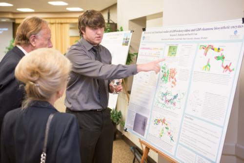 A scholar shows his research during the S3 Showcase in Kirkhof Center.