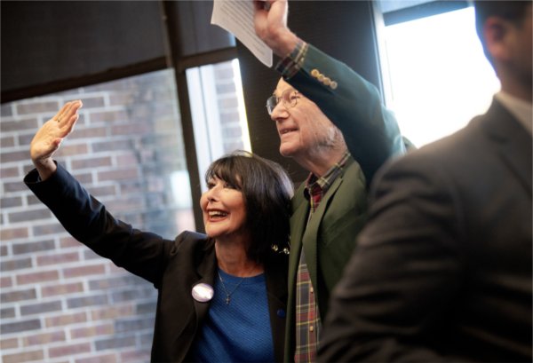 President Mantella and Bob Thompson wave to students