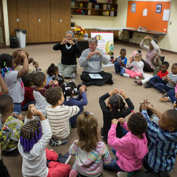 About 40 preschool students at Explore and Learn Academy in Grand Rapids sat on the floor with President Thomas J. Haas to hear all about The Sandwich Swap.