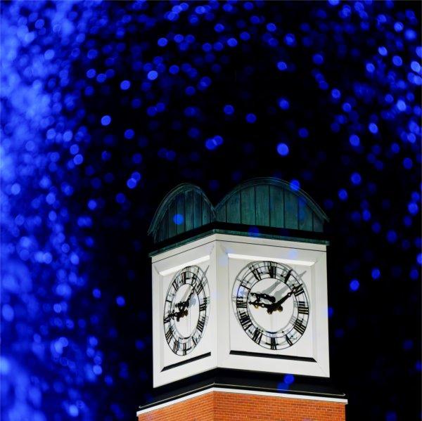 The Cook Carillon Tower is pictured through the blue water of the Zumberge Pond fountain.