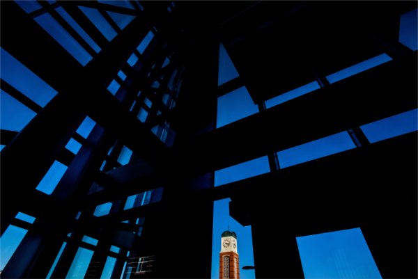 A carillon tower is seen through the windows of the Kirkhof Center. 