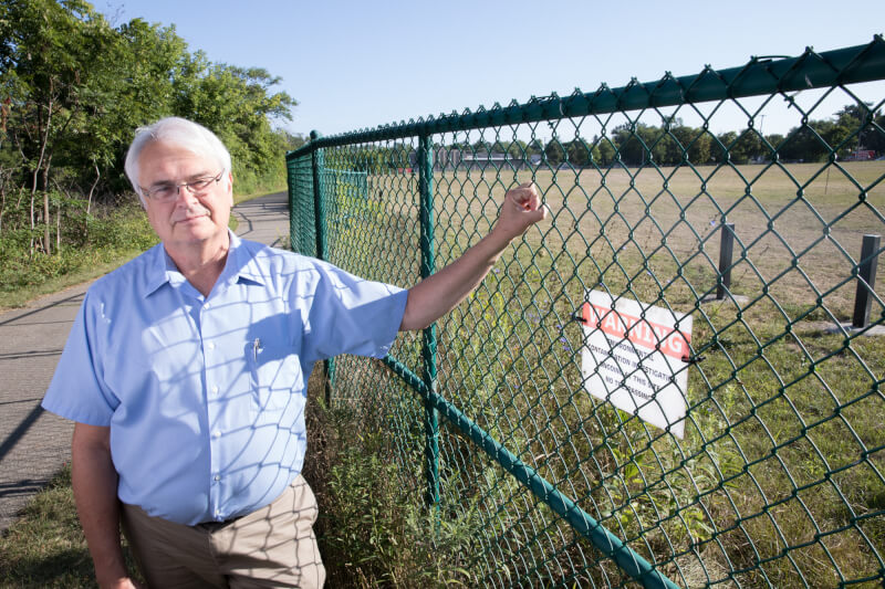 Rick Rediske stands next to the contaminated site of the former Wolverine Worldwide tannery in Rockford, Michigan.