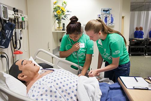 Students participating in simulation exercises using a dummy patient. Photo by Jess Weal.
