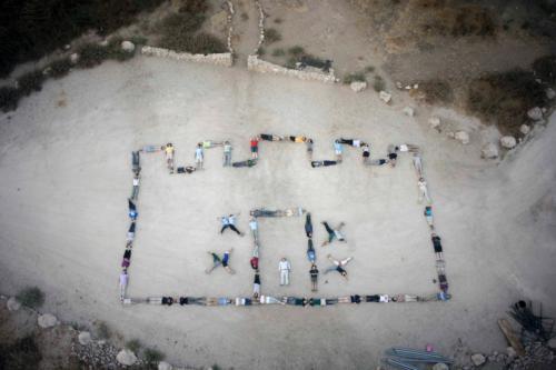 Grand Valley students and Elizabeth Arnold, associate professor of anthropology, as well as more than 80 students, volunteers and professional archaeologists create an outline of the discovered gate to the biblical city of Gath in Israel.