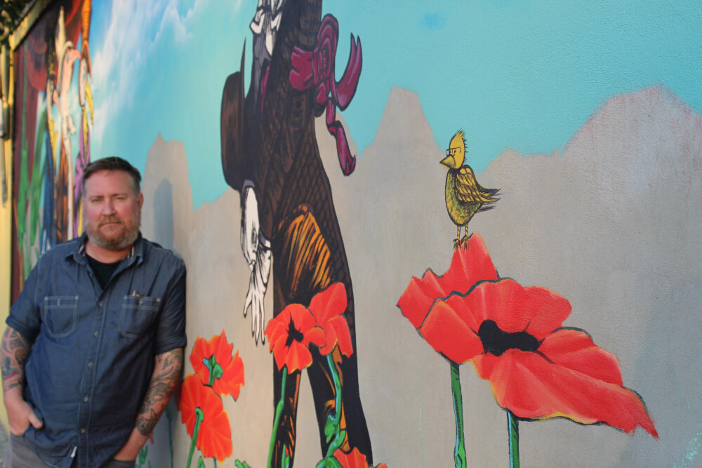 Tim Fisher pictured with Bielsko Biala mural. Photo courtesy of Tim Fisher.