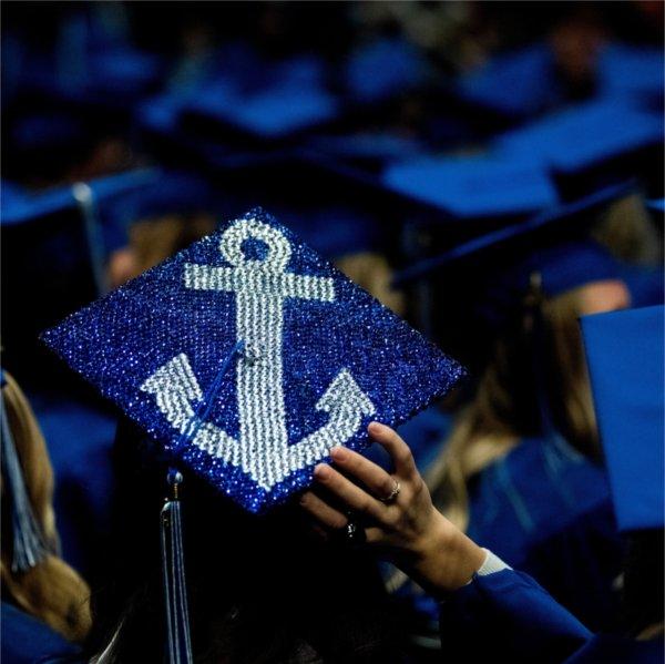 The top of a graduation cap, bedazzled with an anchor.