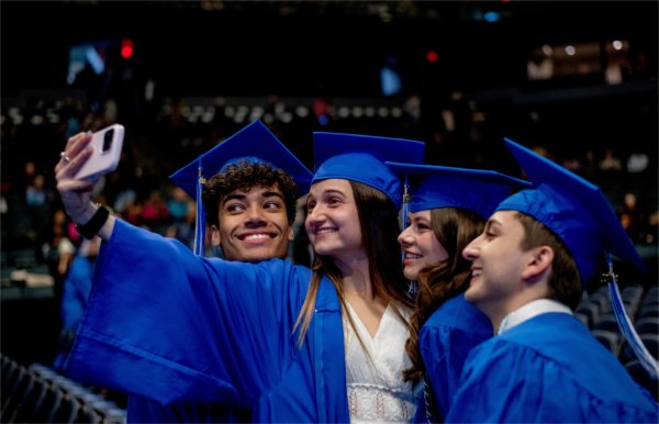 Graduating students take a selfie together.