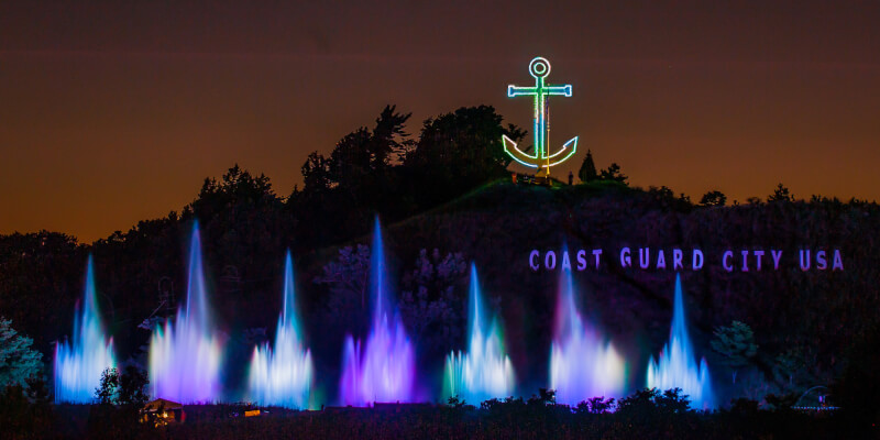  Fountain and lights show at night with an anchor on display