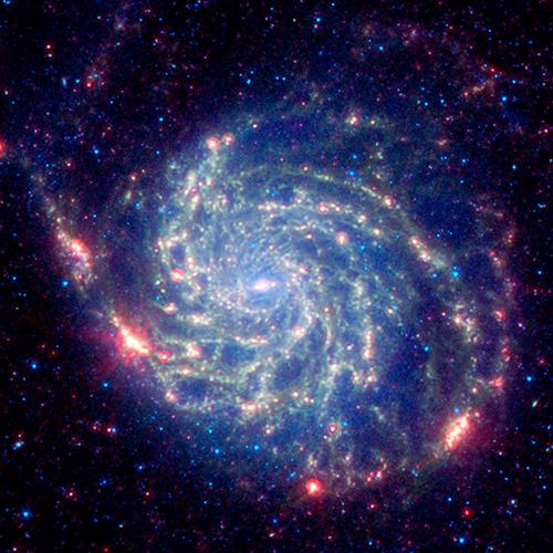 The galaxy Messier 101 is a swirling spiral of stars, gas, and dust. It is nearly twice as wide as the Milky Way galaxy. The photo, captured by NASA�s Spitzer Space Telescope, reveals the galaxy's delicate dust lanes as yellow-green filaments.  