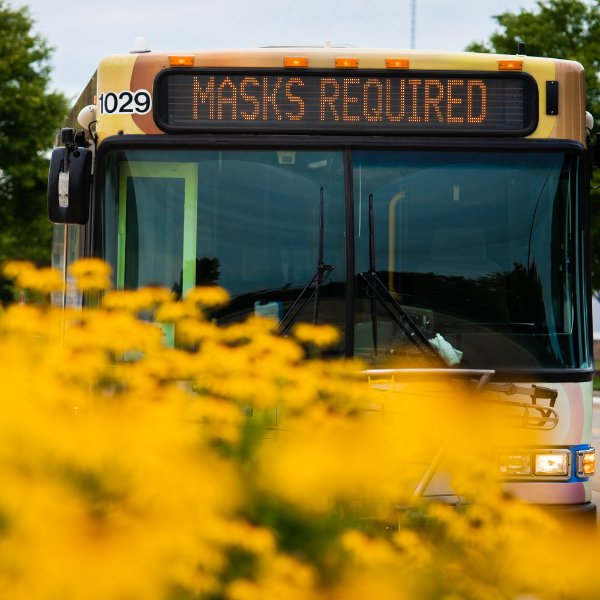 Rapid bus with sign that says masks required
