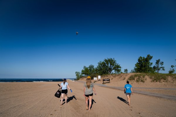 Lexy Porter, Maggie Brenneman and Molly Lane (left to right) walk down Pere Marquette Beach in Muskegon.