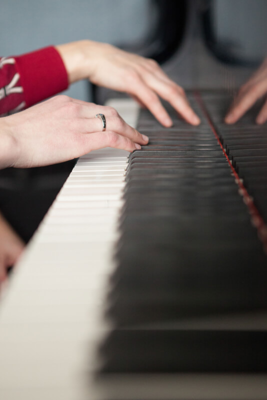 Photo of hands playing a piano