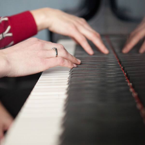 Photo of hands playing a piano