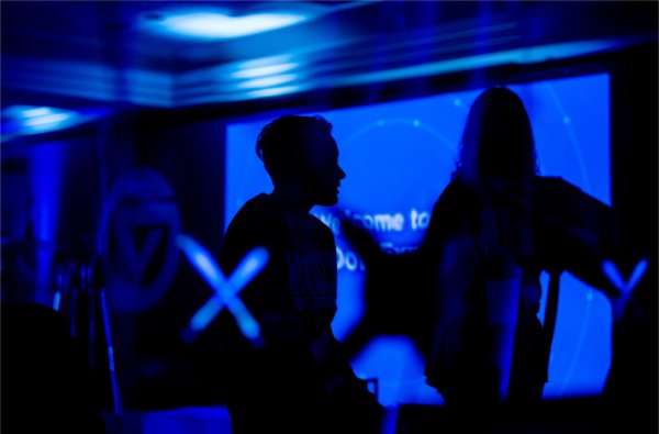 Kate Borgne, a Grand Valley student working with Project Grand Path, is silhouetted against a screen during GVSU's "The Blue Dot Experience," event as part of Tech Week GR. 