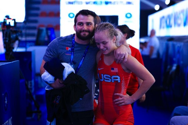 Sage Mortimer celebrates her gold medal victory at the Under-23 World Championships in Albania with head coach Jake Short 