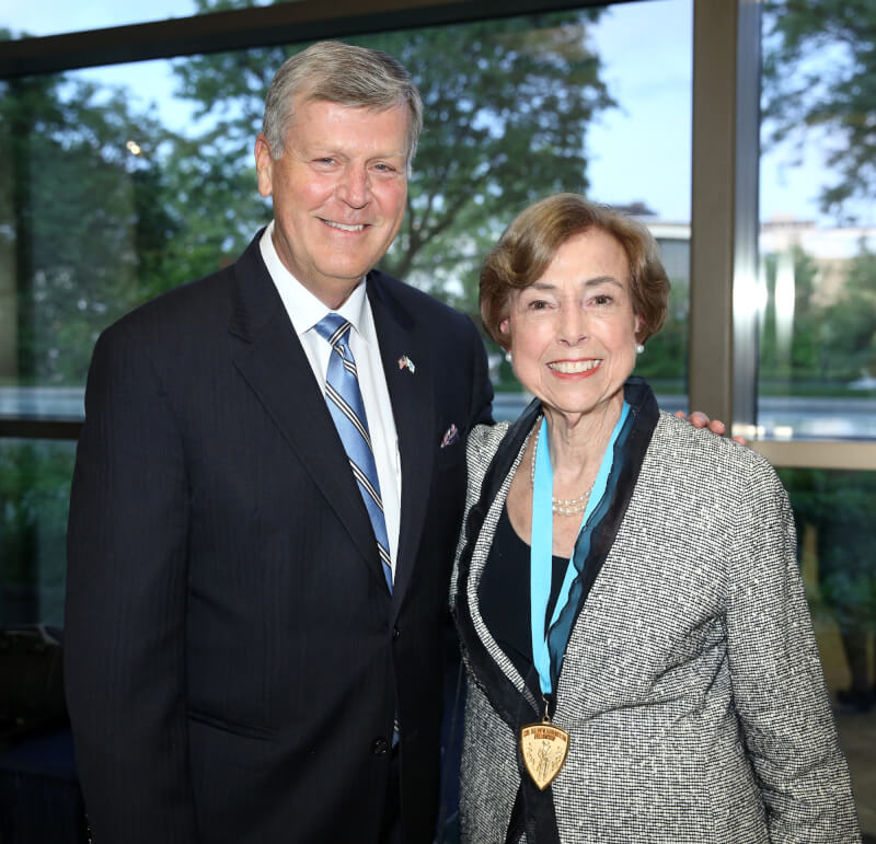 President Thomas J. Haas and Ambassador Carla Hills pose for a photograph in the lobby of the Ford Presidential Museum in Grand Rapids.