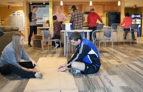 Movement science students assemble cardboard games for an event on October 4.
