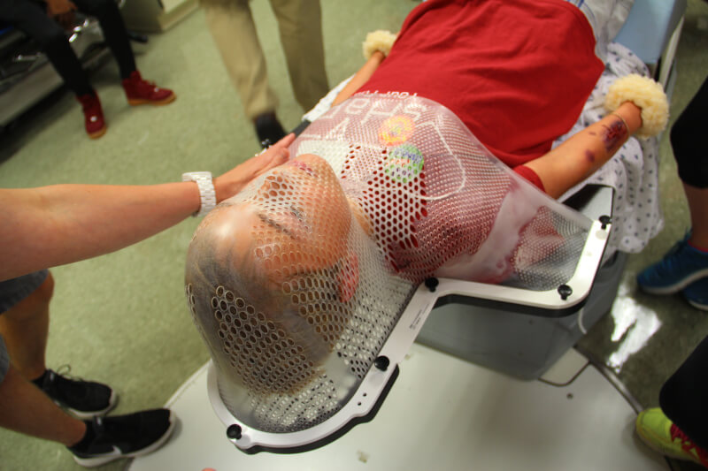 A camper is fitted for a dosimetry cage, which is used for immobilizing a patient during radiation therapy