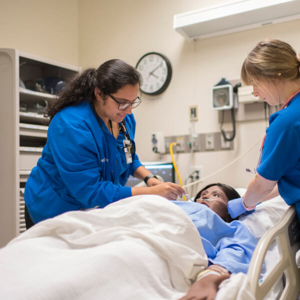 Nursing students practice on Sim Lab patients in the Cook-DeVos Center for Health Sciences.