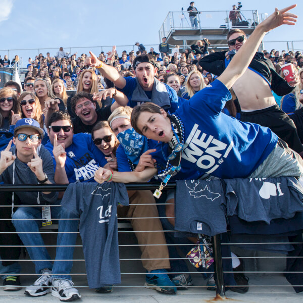 Students take in a football game at Lubbers Stadium.