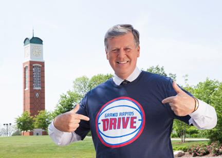 President Thomas J. Haas poses with a Grand Rapids Drive t-shirt in Allendale. The basketball team announced its name June 17 via a social media campaign.