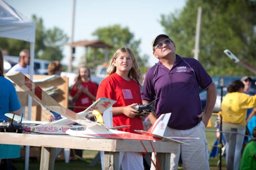 Past campers fly the airplanes they made during STEPS Camp at the Warped Wings Fly Field in Allendale.