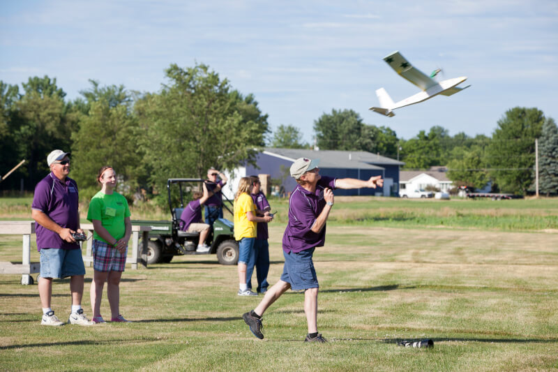 A photos of campers flying their airplanes.