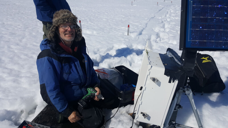 Robert Hollister, professor of biology, making repairs to data loggers in Utqiagvik, Alaska.