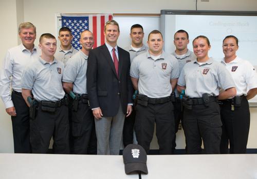 U.S. Rep. Bill Huizenga, center, President Haas, far left, and GVSU Police Academy director Julie Yunker, far right, are pictured with students in the Military Police Basic Training Program at GVSU.