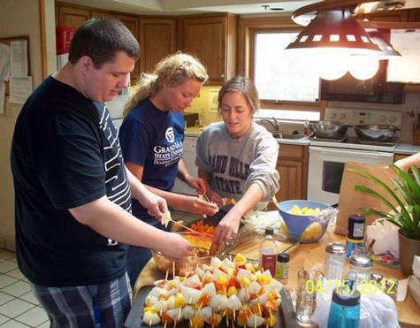 From left, Benjamin Hartley, Emma Perkins and Kelly DeVoursney prepare a meal for the Ronald McDonald House.