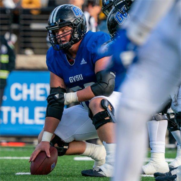 Center gets in position to snap the football.