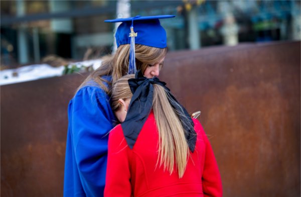  A graduate and her daughter share a moment. 