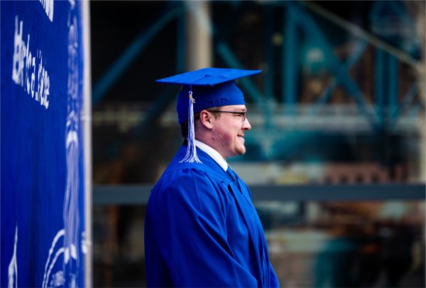 A graduate poses for a photo.  