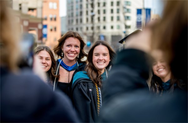 A group of graduates pose for a photo.  