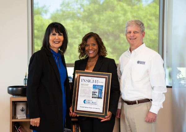 from left are President Mantella, Valerie Rhodes-Sorrelle and Greg Sanial. Valerie is holding a large plaque from Insight Into Diversity.