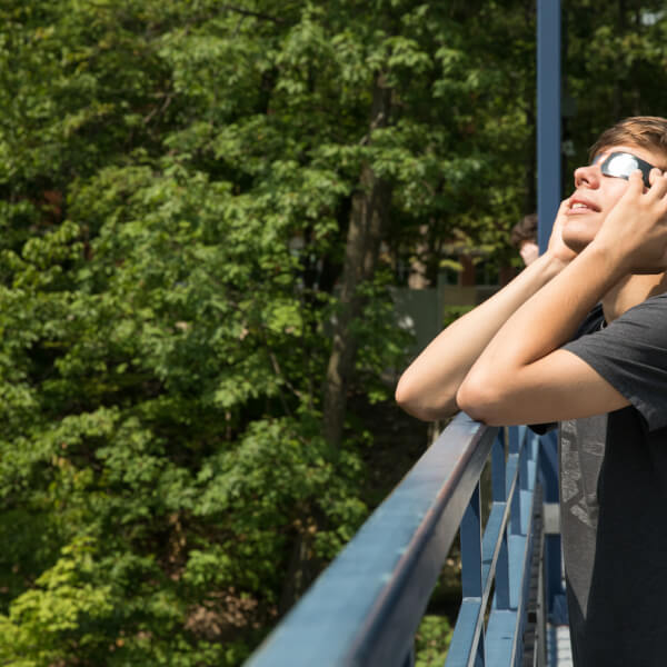 Student watching solar eclipse
