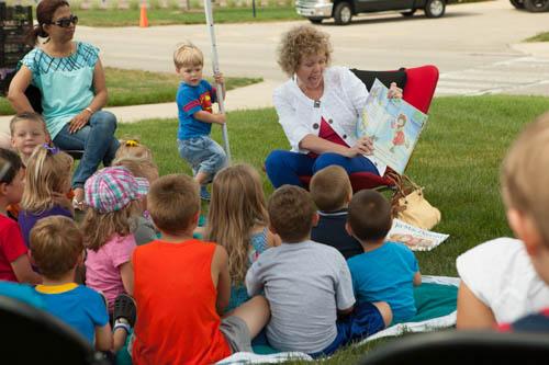 Marcia Haas reads books during the Farmers Market.