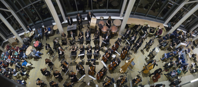 Picture of Symphony Orchestra performing in Mary Idema Pew Library Atrium.