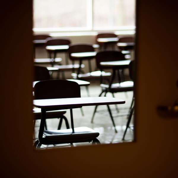 empty classroom shot through door window