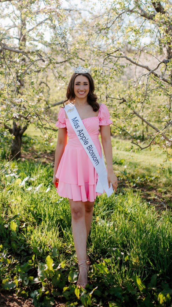 Lauren Mroczek stands wearing her crown and sash as she prepares to compete for Miss Michigan. 
