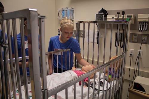 Students at the sHaPe camp learn about the high-tech manikins used at the Cook-DeVos Center for Health Sciences.